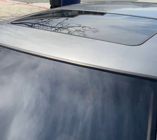 Black roof and sunroof polished to a clean mirror finish after detailing