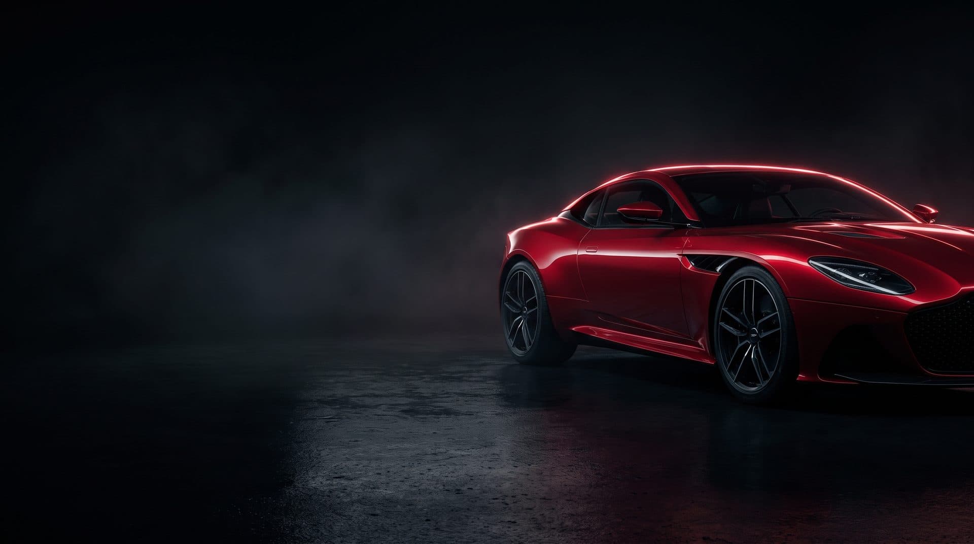 Glossy red luxury sports car detailed in a dark studio