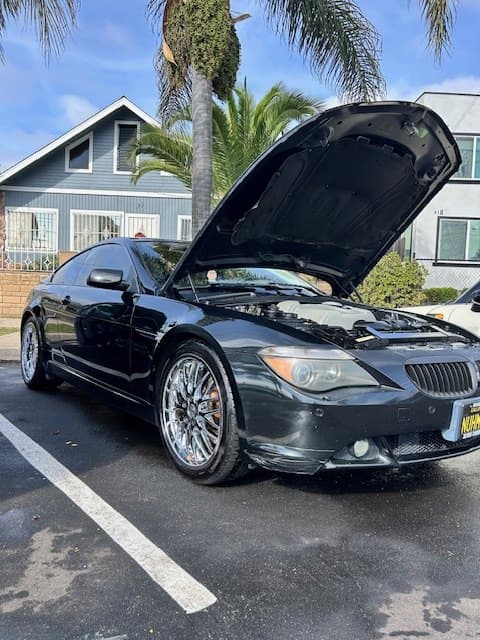 Black coupe with chrome wheels mid-detail